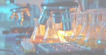 A chemical laboratory that symbolizes scientific research and experimentation, complete with a microscope and flasks filled with liquids.